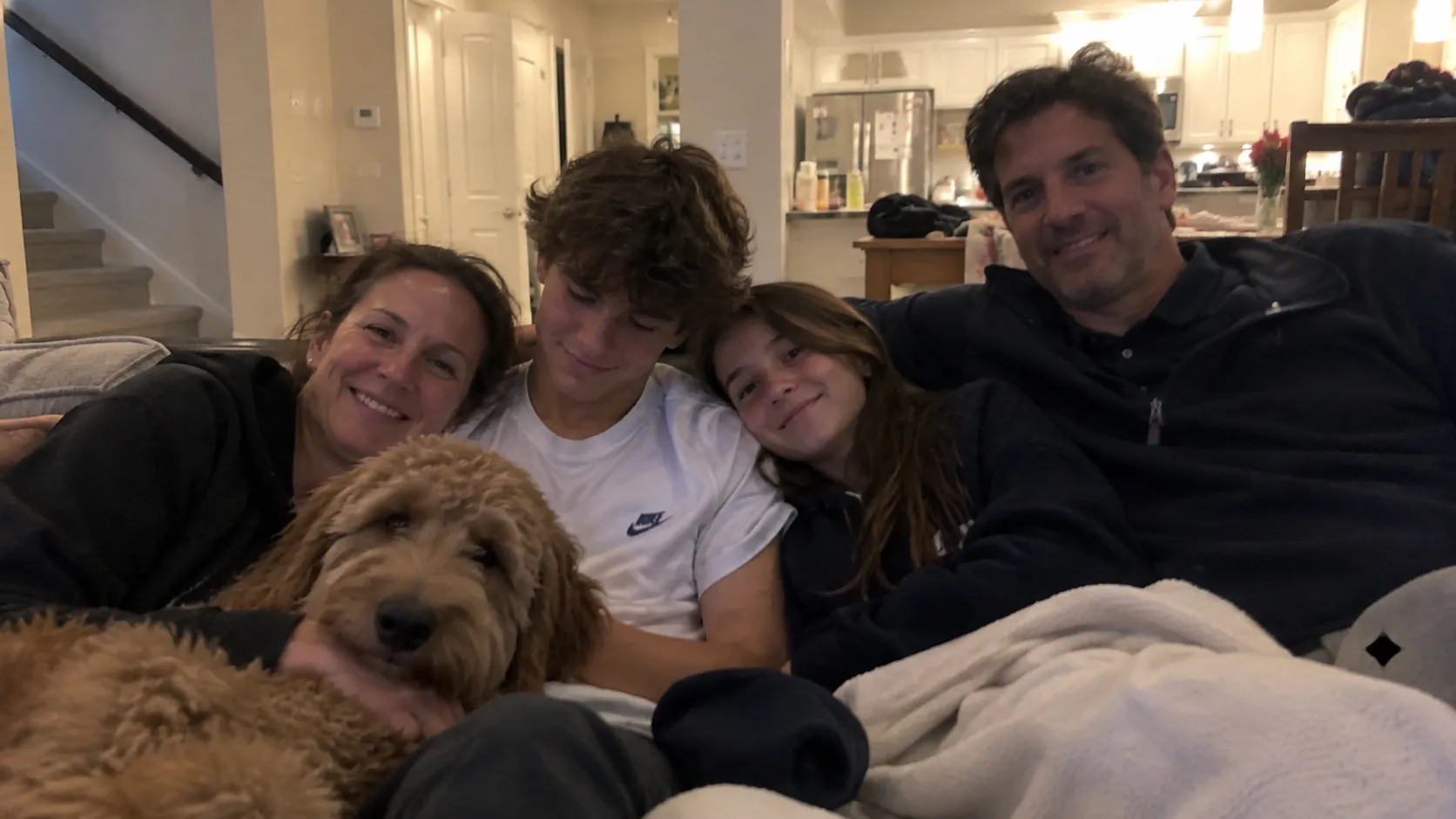 A family at home with their dog, supporters of Detailing for MCAS