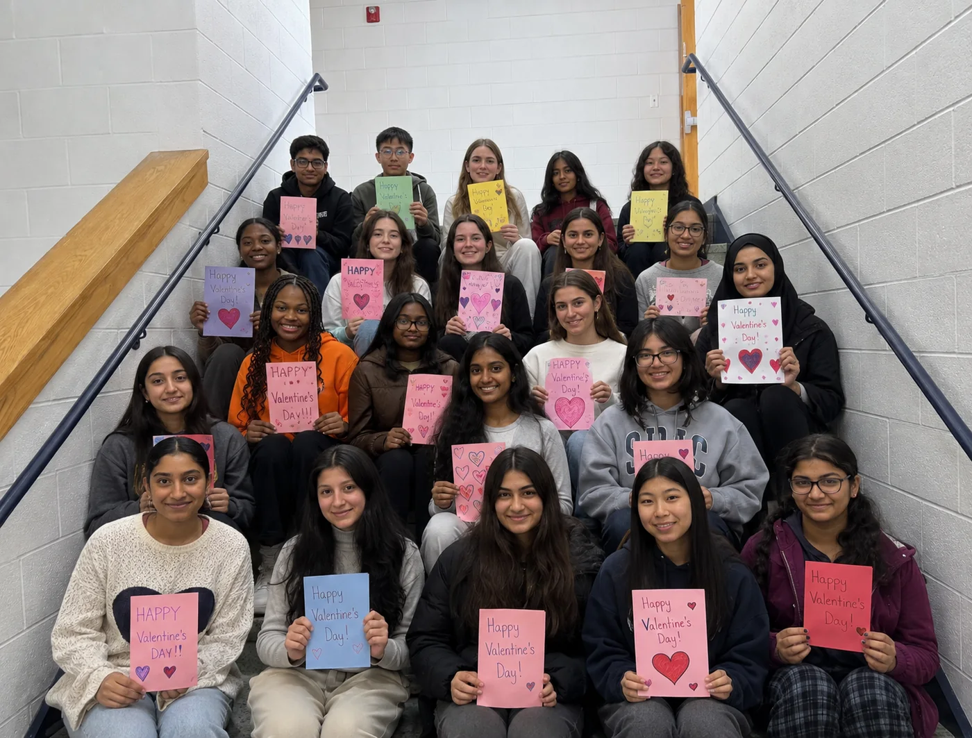 Detailing for MCAS volunteers holding handmade Valentine's Day cards made for hospital patients